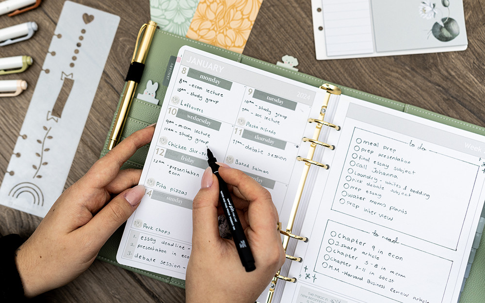 An Organizer with a green ring binder, featuring planning for 2024