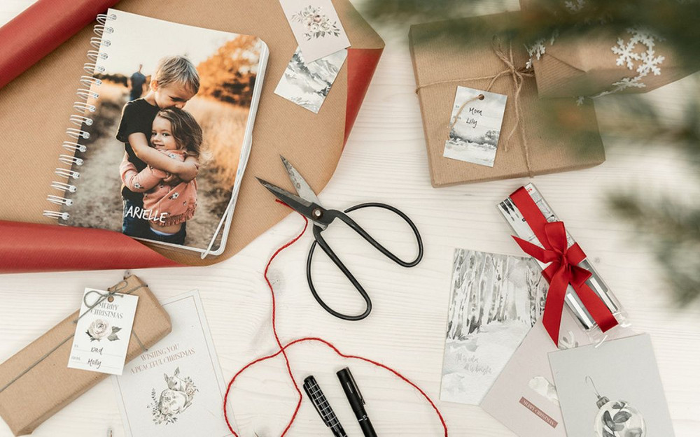 A wrapped calendar, Christmas gifts, Christmas cards, and Christmas gift tags.