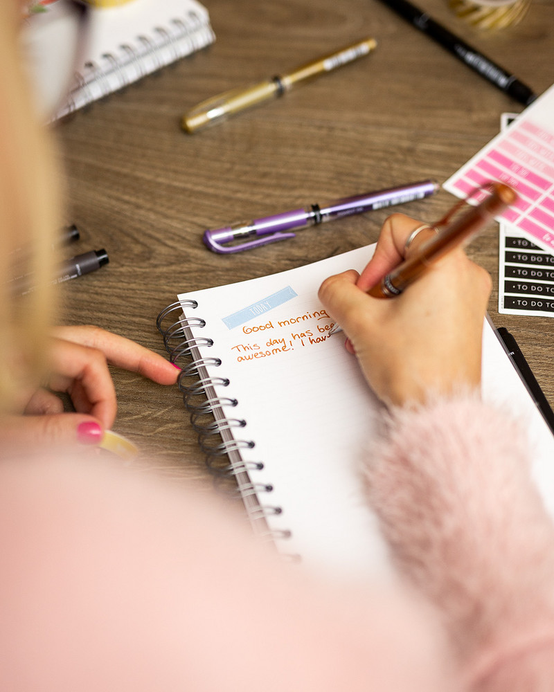 Open notebook with colorful markers and pens