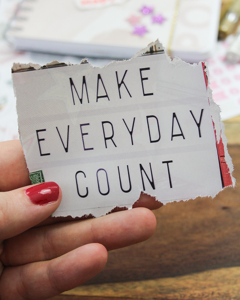 A woman working on her vision board